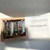 Handblown tequila shot glass with iridescent amber tint.